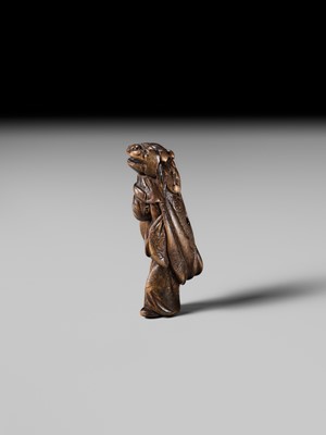 A LARGE HINOKI WOOD NETSUKE OF A SHISHIMAI DANCER