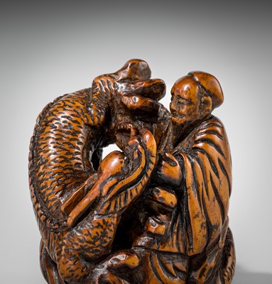Lot 446 - A POWERFUL WOOD NETSUKE OF BASHIKO SENNIN