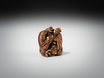 Lot 446 - A POWERFUL WOOD NETSUKE OF BASHIKO SENNIN