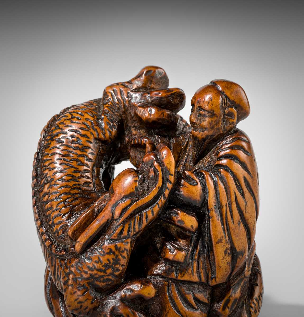 Lot 446 - A POWERFUL WOOD NETSUKE OF BASHIKO SENNIN