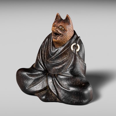 Lot 170 - ANRAKU: A FINE AND HUMOROUS WOOD NETSUKE OF TANUKI DISGUISED AS A PRIEST