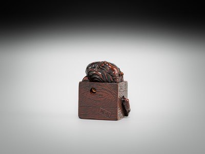 Lot 392 - MASATOMO: A HUMOROUS WOOD NETSUKE OF AN ONI AT SETSUBUN