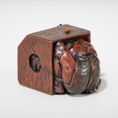 Lot 392 - MASATOMO: A HUMOROUS WOOD NETSUKE OF AN ONI AT SETSUBUN