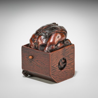 Lot 392 - MASATOMO: A HUMOROUS WOOD NETSUKE OF AN ONI AT SETSUBUN