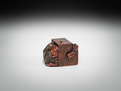 Lot 392 - MASATOMO: A HUMOROUS WOOD NETSUKE OF AN ONI AT SETSUBUN