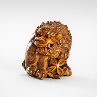 Lot 455 - MASAYUKI: A WOOD NETSUKE OF A SHISHI WITH A BALL
