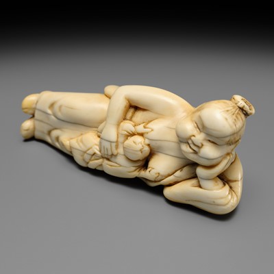 Lot 103 - AN EARLY IVORY NETSUKE OF OKAME WITH CHILD