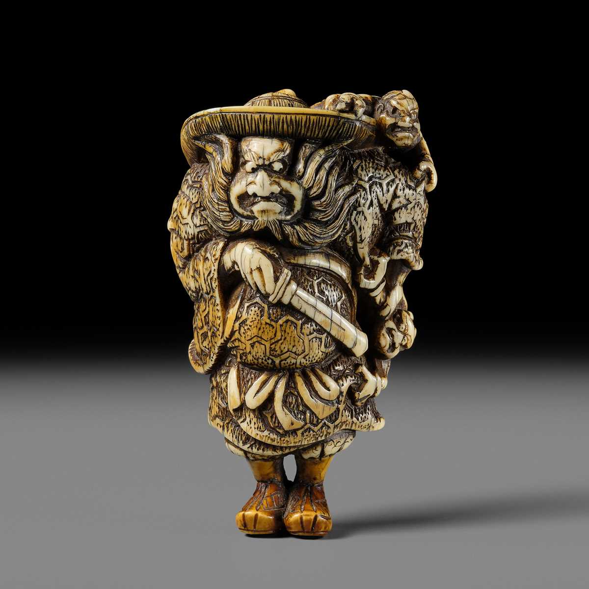Lot 127 - A POWERFUL KYOTO SCHOOL IVORY NETSUKE OF SHOKI AND ONI