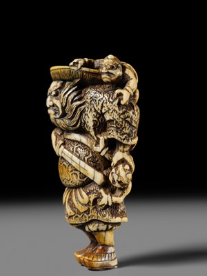 Lot 127 - A POWERFUL KYOTO SCHOOL IVORY NETSUKE OF SHOKI AND ONI