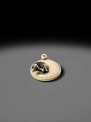 MITSUHARU: AN IVORY NETSUKE OF A DOG ON A CUSHION
