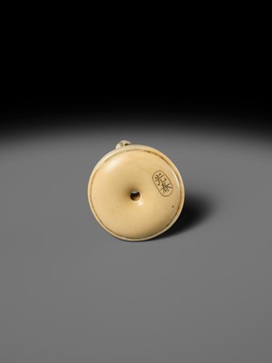 MITSUHARU: AN IVORY NETSUKE OF A DOG ON A CUSHION