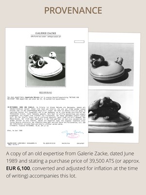 MITSUHARU: AN IVORY NETSUKE OF A DOG ON A CUSHION