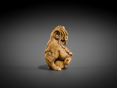Lot 332 - A RARE IVORY NETSUKE OF A SHISHI WITH A BALL