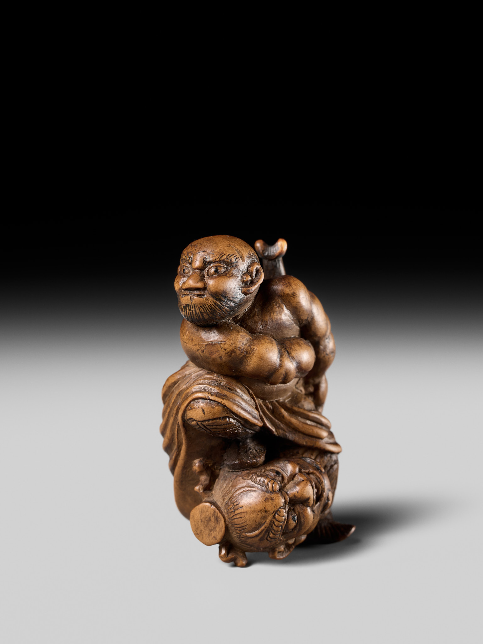 Lot 133 - A RARE WOOD NETSUKE OF ROCHISHIN