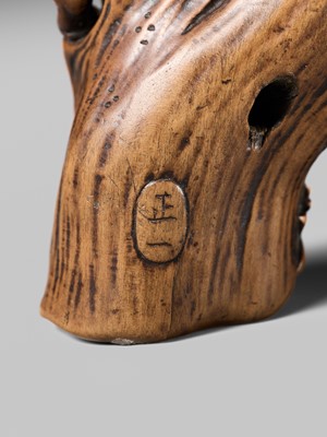 Lot 134 - MASAKAZU: A RARE WOOD NETSUKE OF AN ONI HIDING IN A TREE STUMP