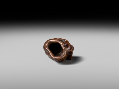 Lot 134 - MASAKAZU: A RARE WOOD NETSUKE OF AN ONI HIDING IN A TREE STUMP