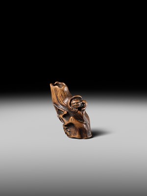 Lot 134 - MASAKAZU: A RARE WOOD NETSUKE OF AN ONI HIDING IN A TREE STUMP