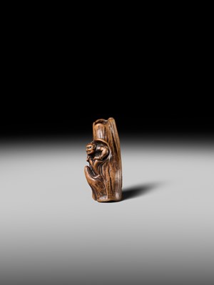 Lot 134 - MASAKAZU: A RARE WOOD NETSUKE OF AN ONI HIDING IN A TREE STUMP