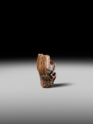 Lot 134 - MASAKAZU: A RARE WOOD NETSUKE OF AN ONI HIDING IN A TREE STUMP
