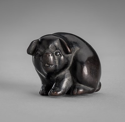 Lot 1548 - A CHARMING KUROGAKI WOOD NETSUKE OF A PUPPY