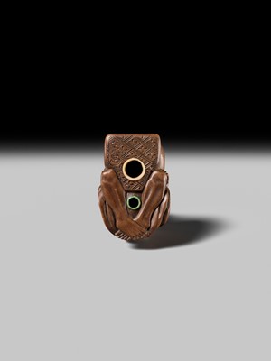 Lot 398 - SUKETADA: AN AMUSING WOOD NETSUKE OF A TANUKI BEATING A MOKUGYO