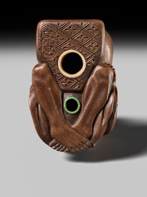 Lot 398 - SUKETADA: AN AMUSING WOOD NETSUKE OF A TANUKI BEATING A MOKUGYO