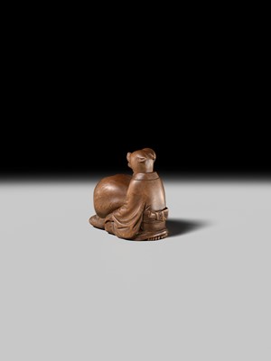 Lot 398 - SUKETADA: AN AMUSING WOOD NETSUKE OF A TANUKI BEATING A MOKUGYO