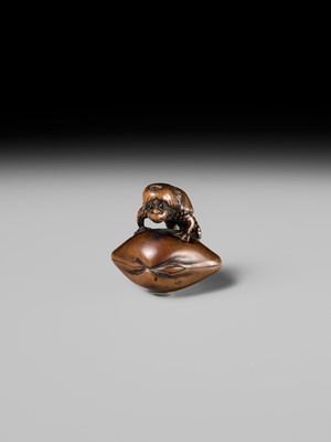 Lot 402 - SUKETADA: A FINE WOOD NETSUKE OF A KAPPA ON HAMAGURI CLAM