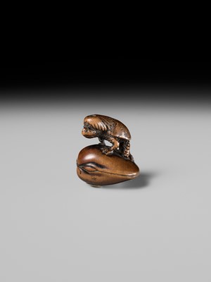 Lot 402 - SUKETADA: A FINE WOOD NETSUKE OF A KAPPA ON HAMAGURI CLAM