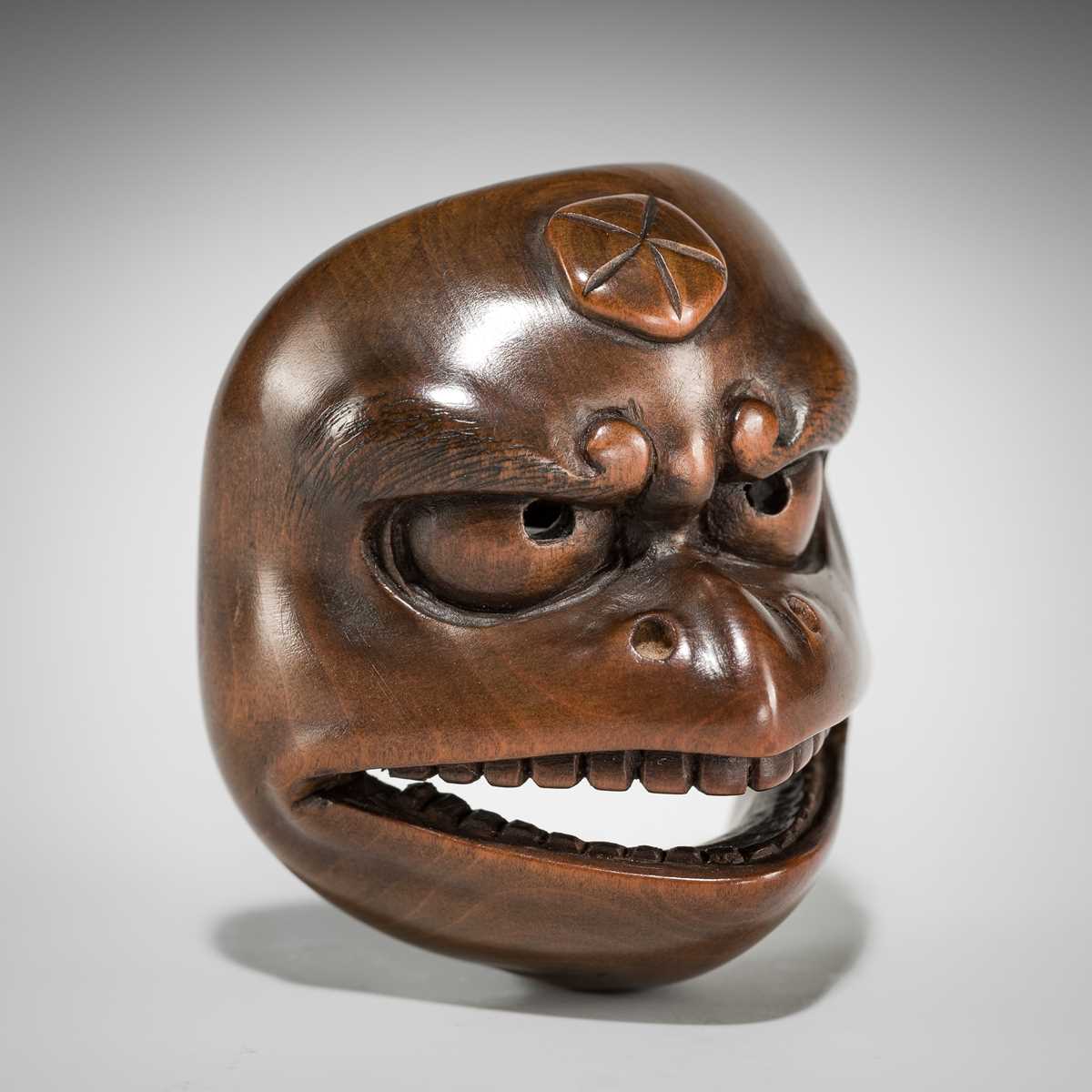 Lot 568 - KOGETSUSAI: A WOOD MASK NETSUKE OF A KARASU