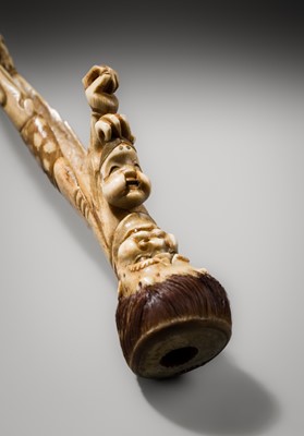 Lot 76 - AN ANTLER KISERUZUTSU (PIPE CASE) OF AN ONI WITH AN OKAME MASK