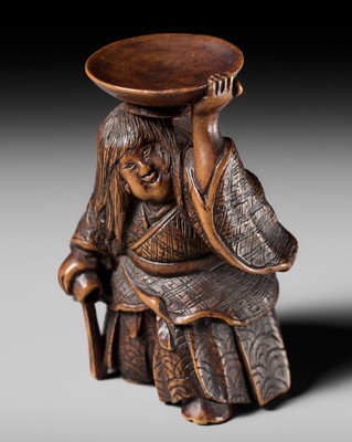 Lot 175 - HIDEHARU: A NAGOYA SCHOOL WOOD NETSUKE OF A DRUNKEN SHOJO BALANCING A SAKE SAUCER