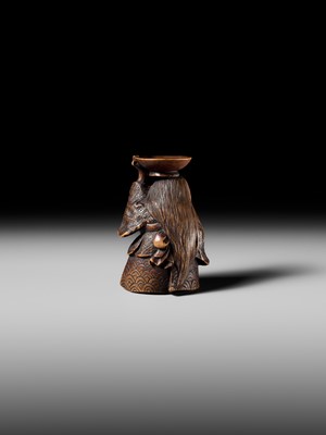 Lot 175 - HIDEHARU: A NAGOYA SCHOOL WOOD NETSUKE OF A DRUNKEN SHOJO BALANCING A SAKE SAUCER