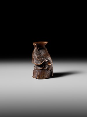 Lot 175 - HIDEHARU: A NAGOYA SCHOOL WOOD NETSUKE OF A DRUNKEN SHOJO BALANCING A SAKE SAUCER