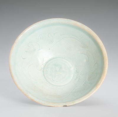 Lot 1085 - A CARVED QINGBAI PORCELAIN BOWL WITH CLOUDS AND FOLIAGE, SONG DYNASTY