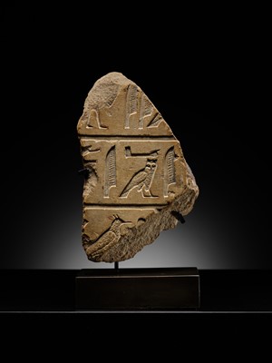 Lot 23 - A LIMESTONE RELIEF FRAGMENT WITH HIEROGLYPHIC INSCRIPTION, OLD KINGDOM OR ARCHAIZING LATE PERIOD