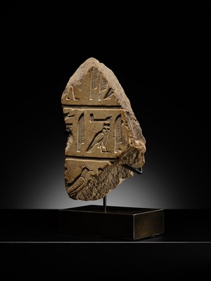 Lot 23 - A LIMESTONE RELIEF FRAGMENT WITH HIEROGLYPHIC INSCRIPTION, OLD KINGDOM OR ARCHAIZING LATE PERIOD