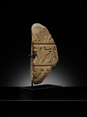 Lot 23 - A LIMESTONE RELIEF FRAGMENT WITH HIEROGLYPHIC INSCRIPTION, OLD KINGDOM OR ARCHAIZING LATE PERIOD