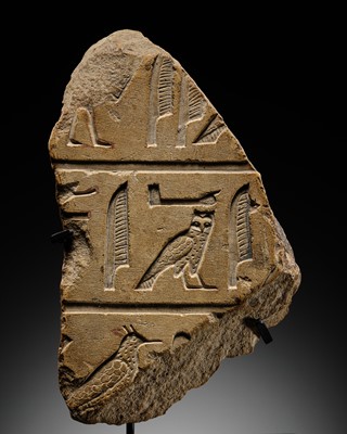 Lot 23 - A LIMESTONE RELIEF FRAGMENT WITH HIEROGLYPHIC INSCRIPTION, OLD KINGDOM OR ARCHAIZING LATE PERIOD