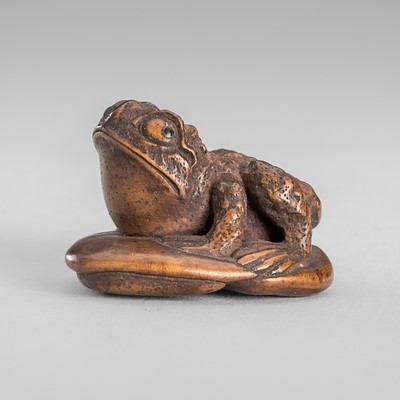 Lot 1660 - SATOCHIKA: AN AMUSING WOOD NETSUKE OF A TOAD ON A MUSHROOM