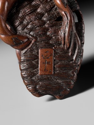 Lot 391 - MASATADA: A FINE WOOD NETSUKE OF A TOAD ON A WARAJI