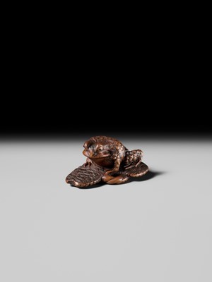 Lot 391 - MASATADA: A FINE WOOD NETSUKE OF A TOAD ON A WARAJI