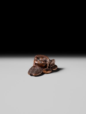 Lot 391 - MASATADA: A FINE WOOD NETSUKE OF A TOAD ON A WARAJI
