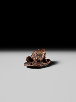 Lot 391 - MASATADA: A FINE WOOD NETSUKE OF A TOAD ON A WARAJI