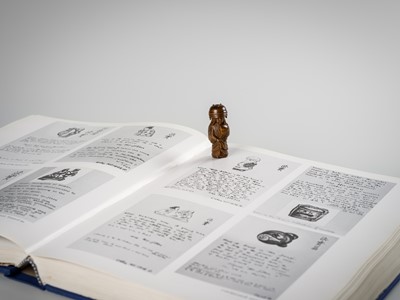 Lot 255 - HOJITSU: A FINE WOOD NETSUKE OF NABE KABURI