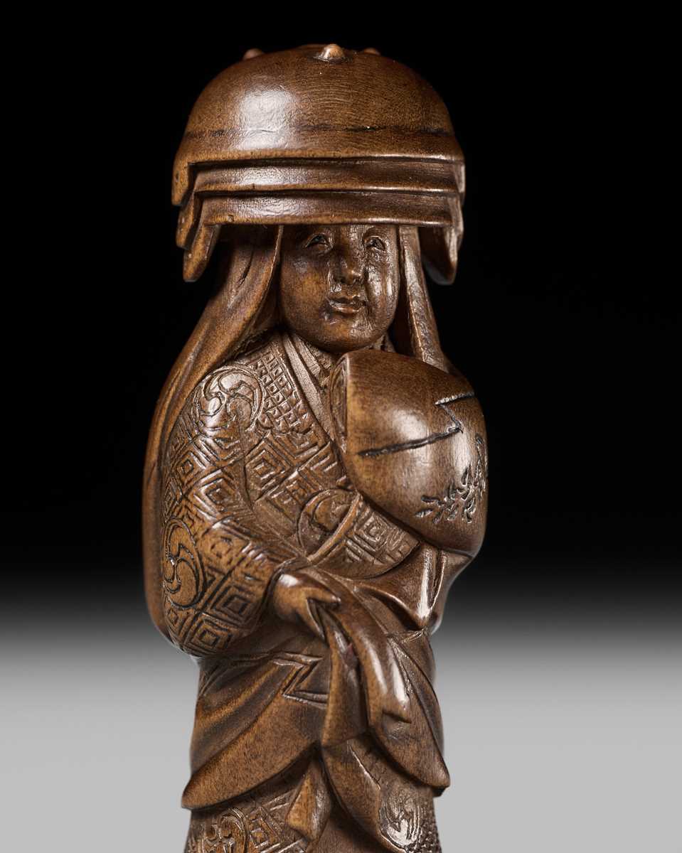 Lot 255 - HOJITSU: A FINE WOOD NETSUKE OF NABE KABURI