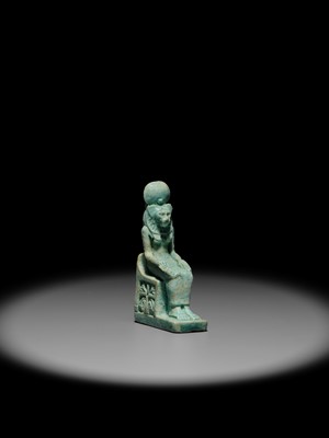 A LARGE TURQUOISE-GLAZED FAIENCE AMULET OF THE ENTHRONED SEKHMET, LATE PERIOD