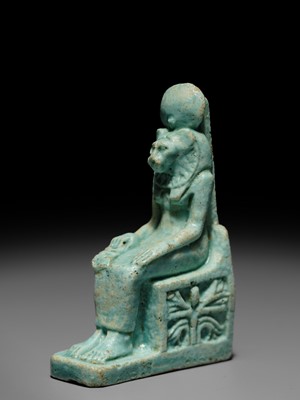 A LARGE TURQUOISE-GLAZED FAIENCE AMULET OF THE ENTHRONED SEKHMET, LATE PERIOD