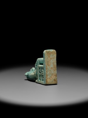 A LARGE TURQUOISE-GLAZED FAIENCE AMULET OF THE ENTHRONED SEKHMET, LATE PERIOD