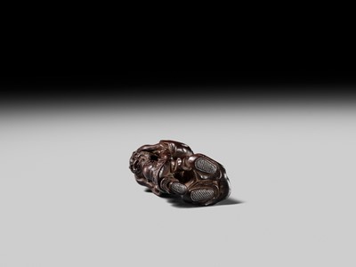 Lot 132 - HIDEMASA: A WOOD NETSUKE DEPICTING A CHINESE MAN SCARING A KARAKO